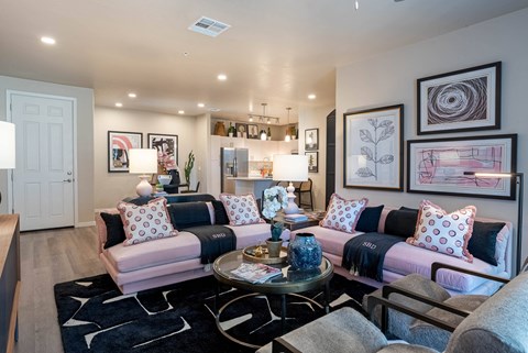 a living room with couches and chairs and a table